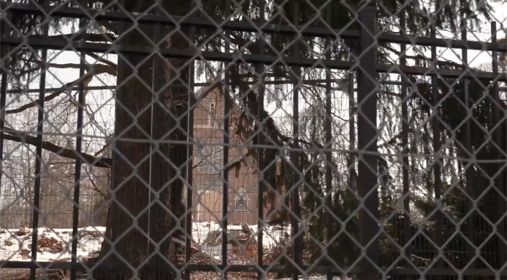 Former Maria Regina College campus building behind fences. Photo by Janice Ha