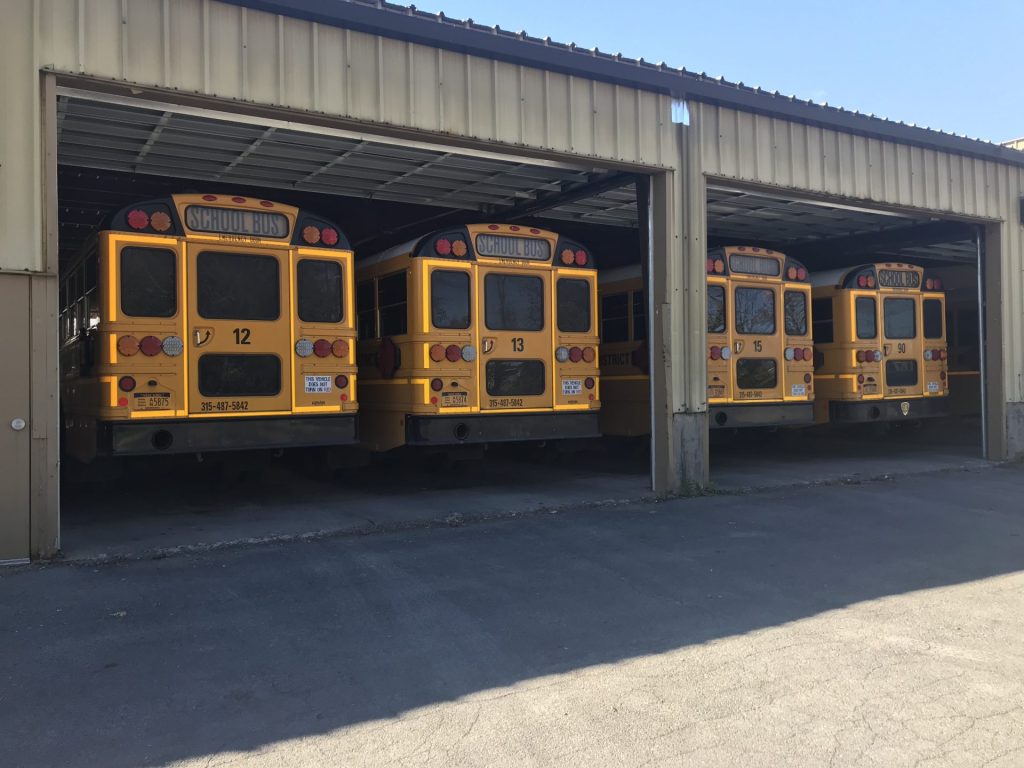 School buses lined up ready to depart the garage