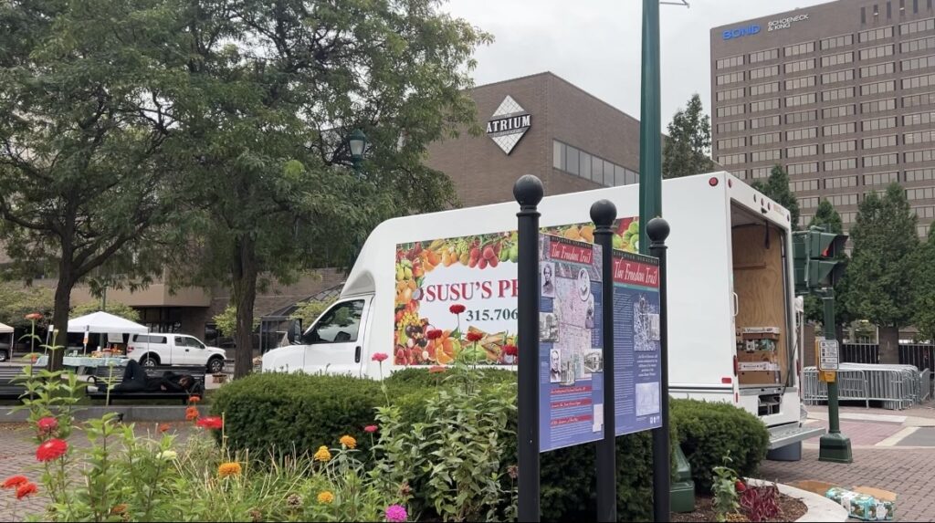 A Syracuse farm truck for one of the farmers market booths unloading its produce.