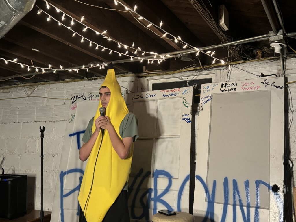 Jack Barsh performing on stage in a bannana suit. 