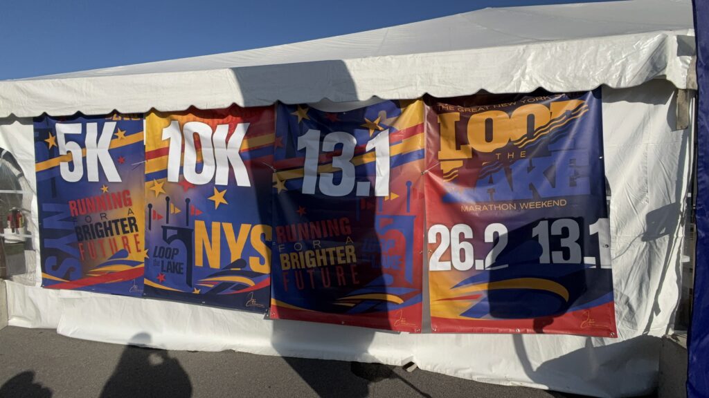 Tent displaying the four events offered: the 5K race, the 10K race, the half marathon and full marathon