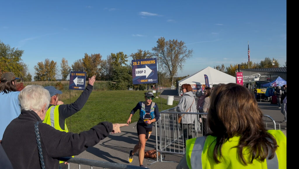 A woman finishes the first of two laps of the full marathon