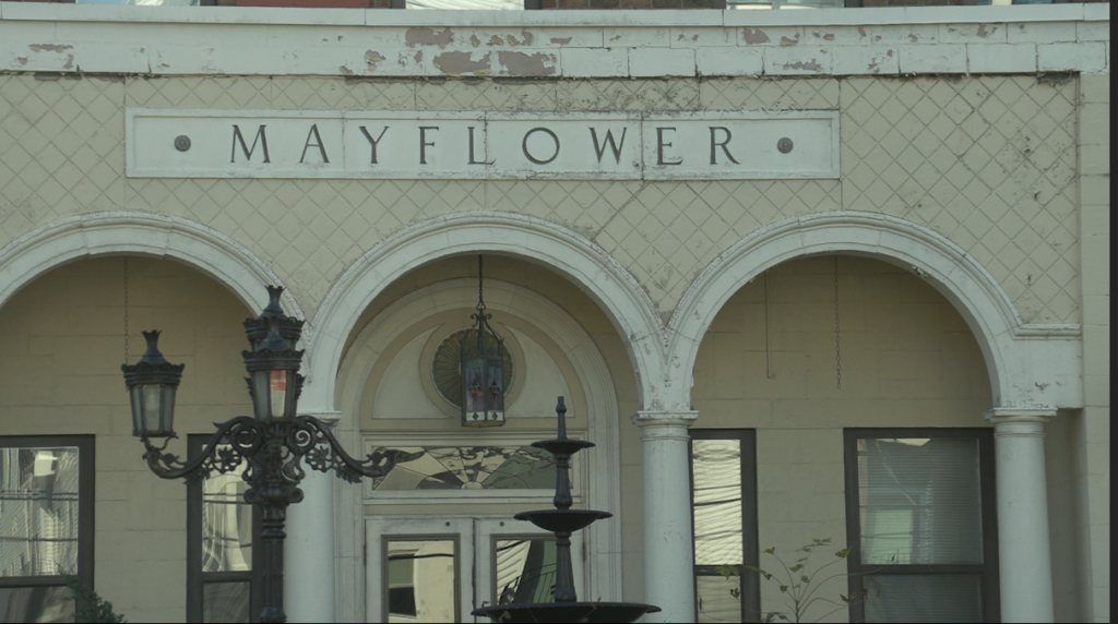 The exterior of a rundown building's exterior with a title head that says "Mayflower."