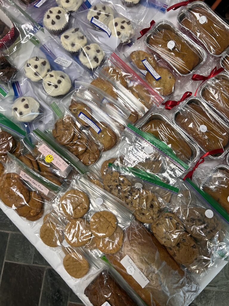 Cookies, muffuns, and breads positioned on a table.