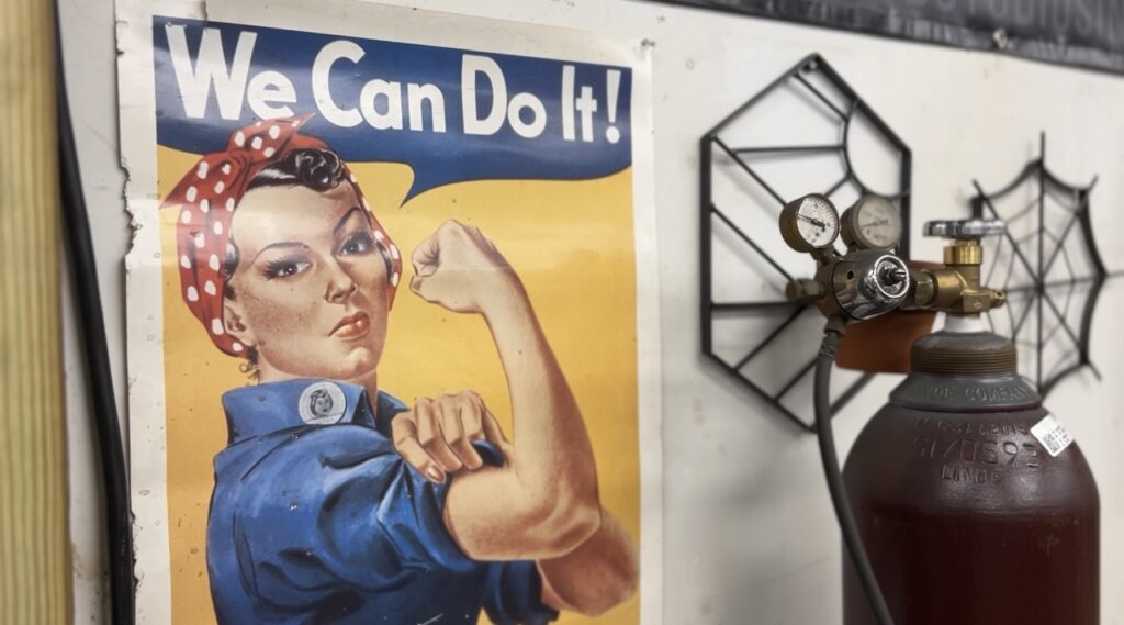 Rosie the Riveter poster beside welding tank.