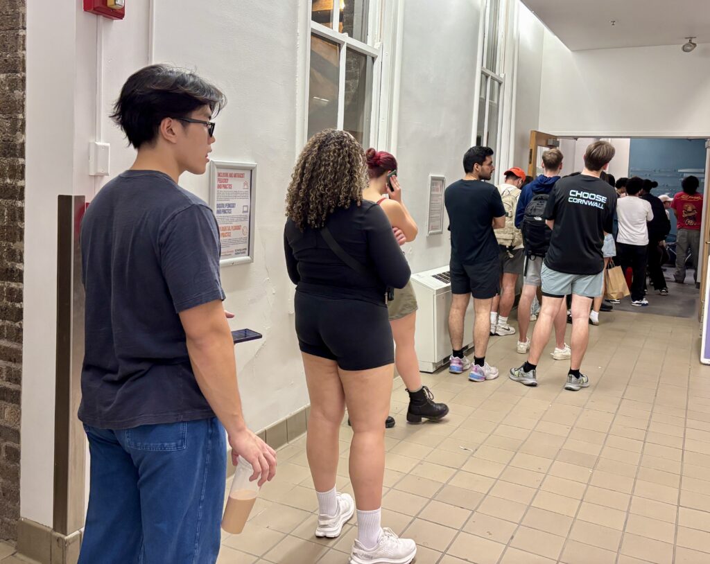 College students line up in Syracuse University's Huntington Hall to vote on Election Day.