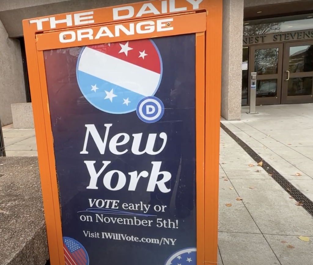 Orange and blue mailbox encouraging New Yorker's to vote early or on election day. © 2024 Alexa LaMalfa