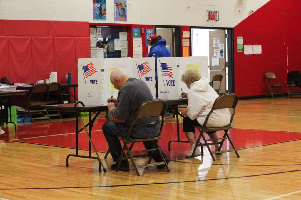 A couple sits down and fills out their ballots at Blessed Sacrament School in Syracuse, NY on November 5, 2024. For many people they have voted at every single election since they were old enough.