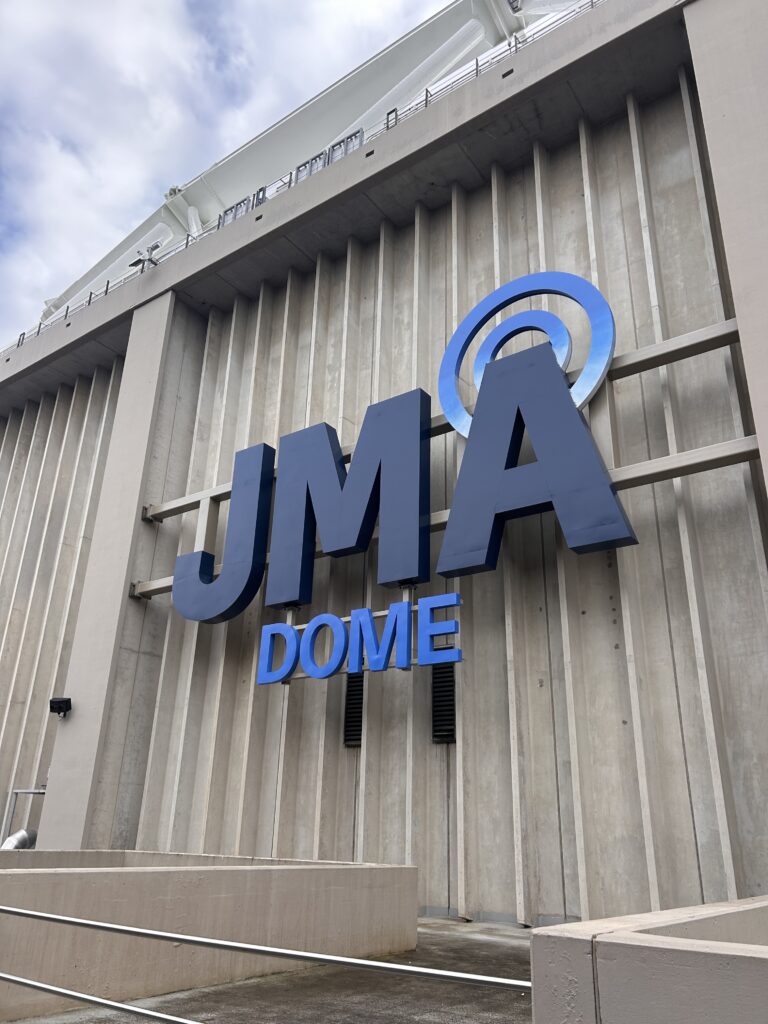 Sign that reads "JMA Dome" on the exterior of the Dome.