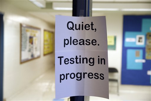 A poster in a school that says "Quiet, please. Testing in progress."