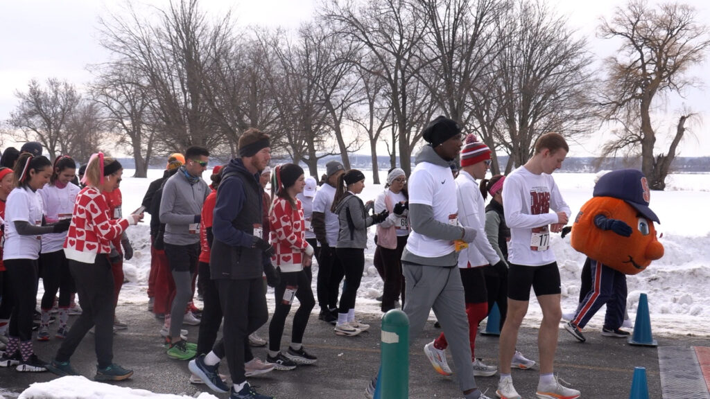 Runners walk to the starting line for the Cupid's Chase 5k in Liverpool, New York.