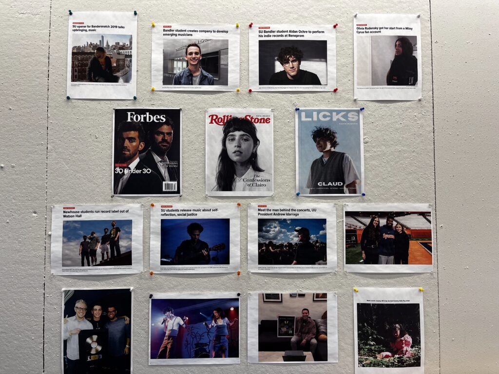 Photos of Bandier alums and previous performers at SU on the wall.