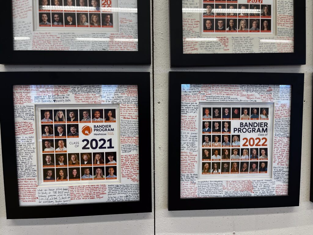 Two frames which hold photos of 2021 and 2022 alumni and their signatures.