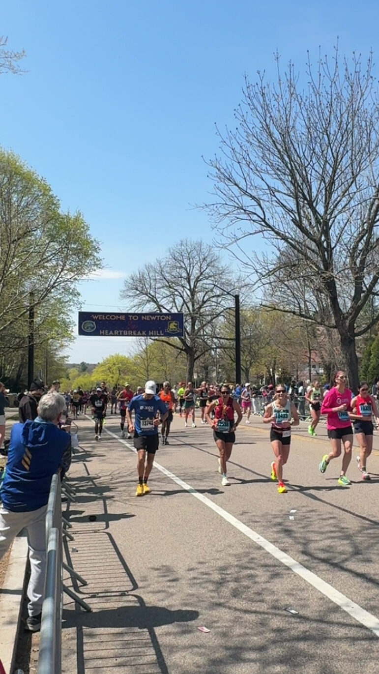 Runners run past Newtons Heartbreak Hill at mile 20.
