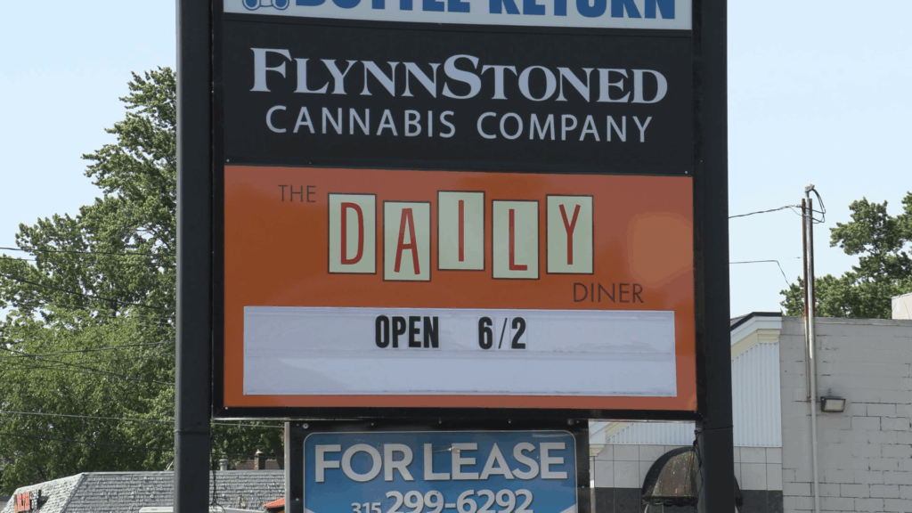 A sign outside of The Daily Diner that reads "The Daily Diner: Open 6/2.