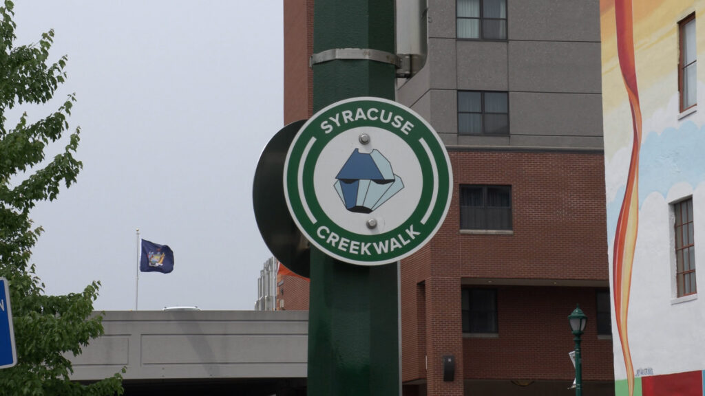 A sign in Armory Square that reads "Syracuse Creek Walk."