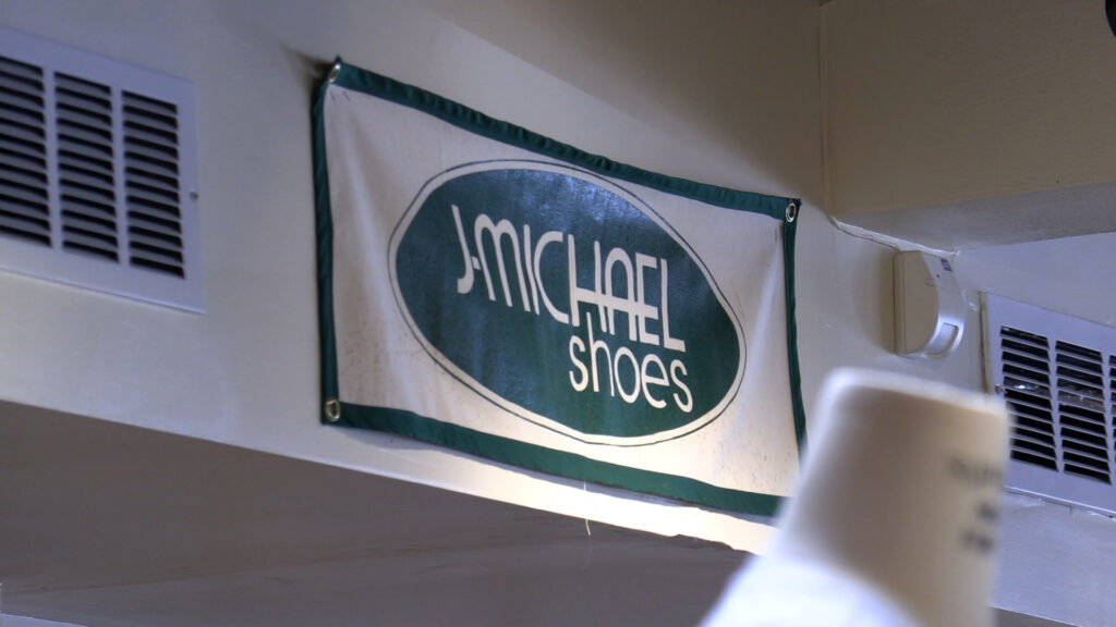 A sign inside of J. Michael Shoes in Syracuse, that reads "J. Michael Shoes."