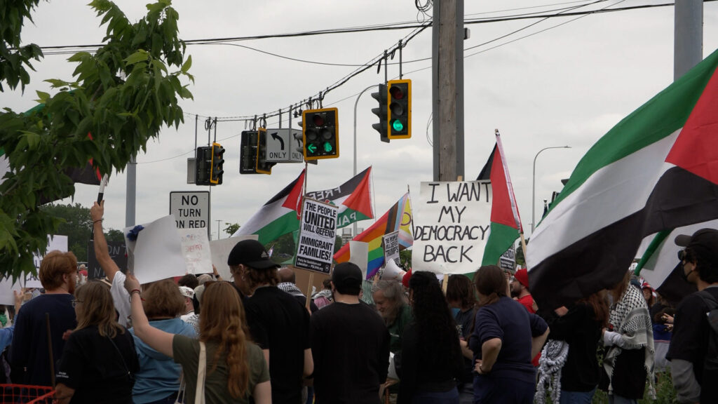 Protesters chanting in solidarity against the Trump administration.