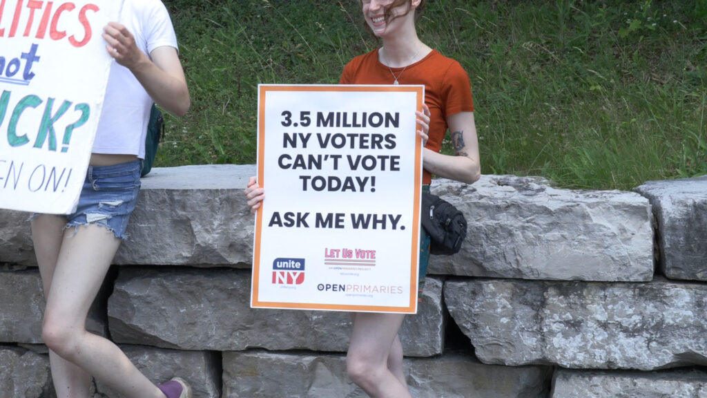 Sign held by Unite NY person