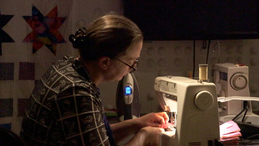 Rachel Ivy Clarke stitching together the Spring quilt block. @ Geraldine Paglia 2025