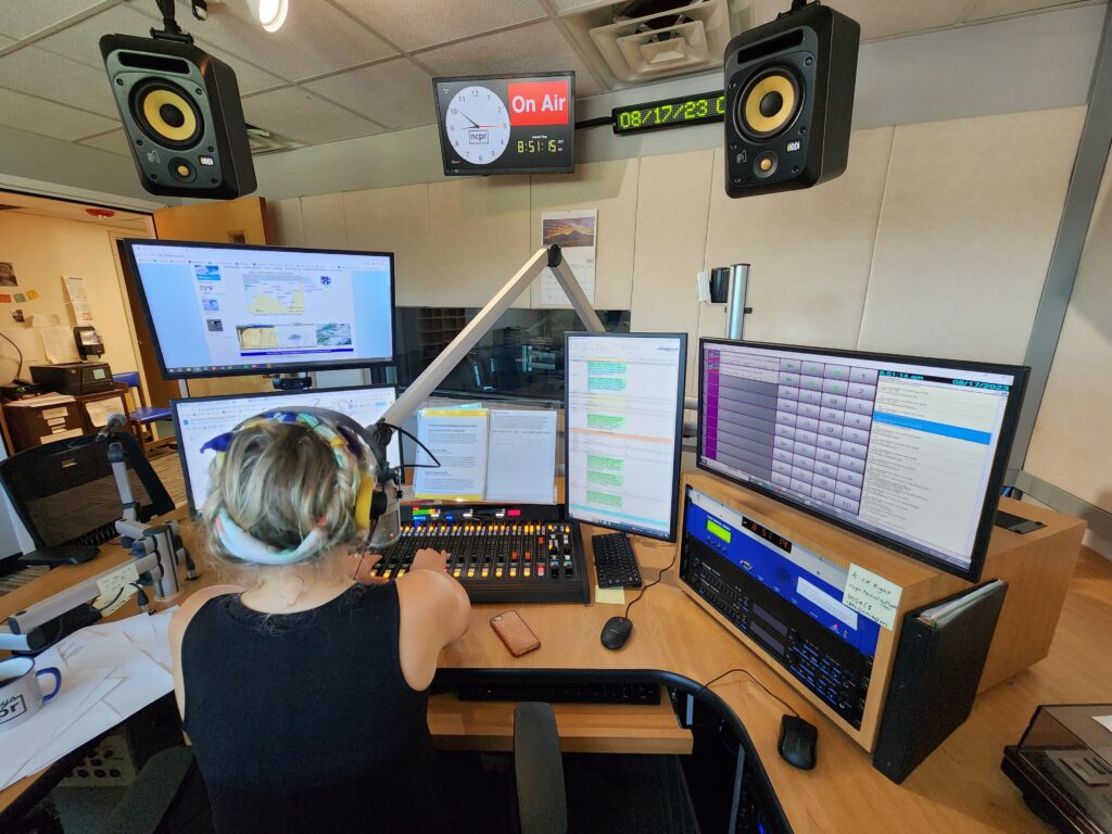 NPR Studio Desk with monitors and audio equipment.