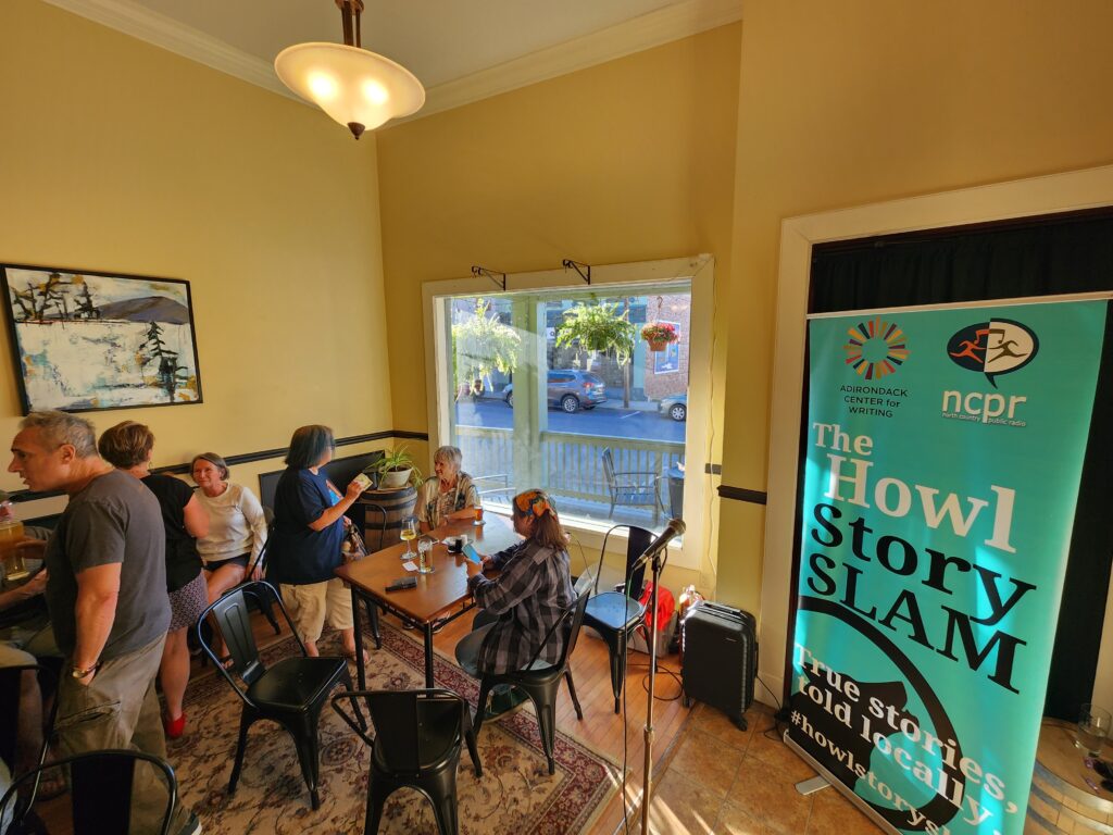 NCPR hosts an event with people socializing in a room with audio equipment and an NCPR banner in the background.
