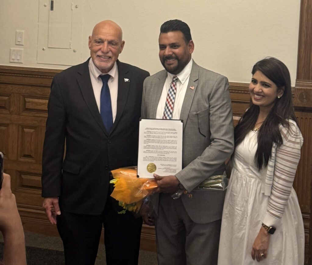 Zeeshawn James, founder of Sai Sewa Adult Day Care, and Councilor Marty Nave, pose for a picture following the Syracuse common council meeting.
