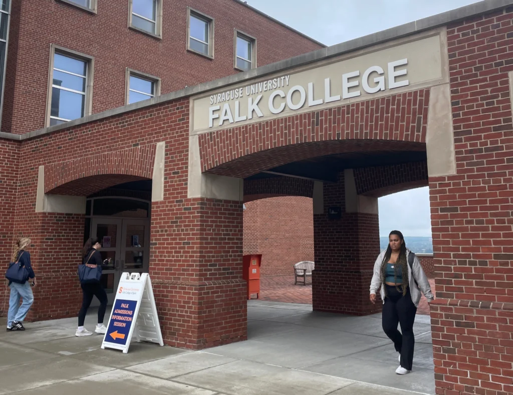 Students walking in and out of Falk main building.
