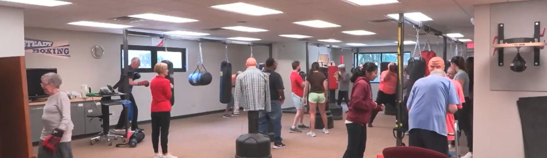 Boxing gym with people training