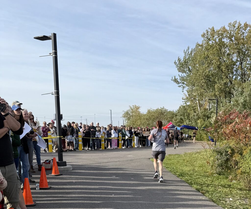 A runner sprints to the finish line. 
