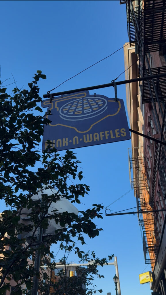 Outside shot of Funk N Waffles sign from their location on S Clinton St.