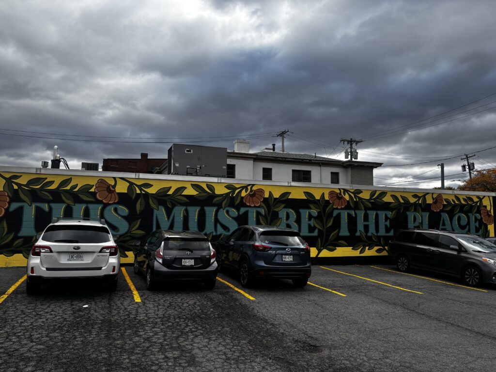A mural outside CNY Jazz Central that says "THIS MUST BE THE PLACE"