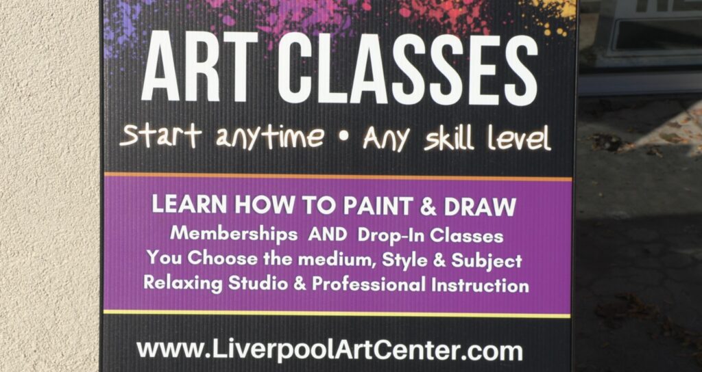 A sign with information about art classes at the Liverpool Art Center.