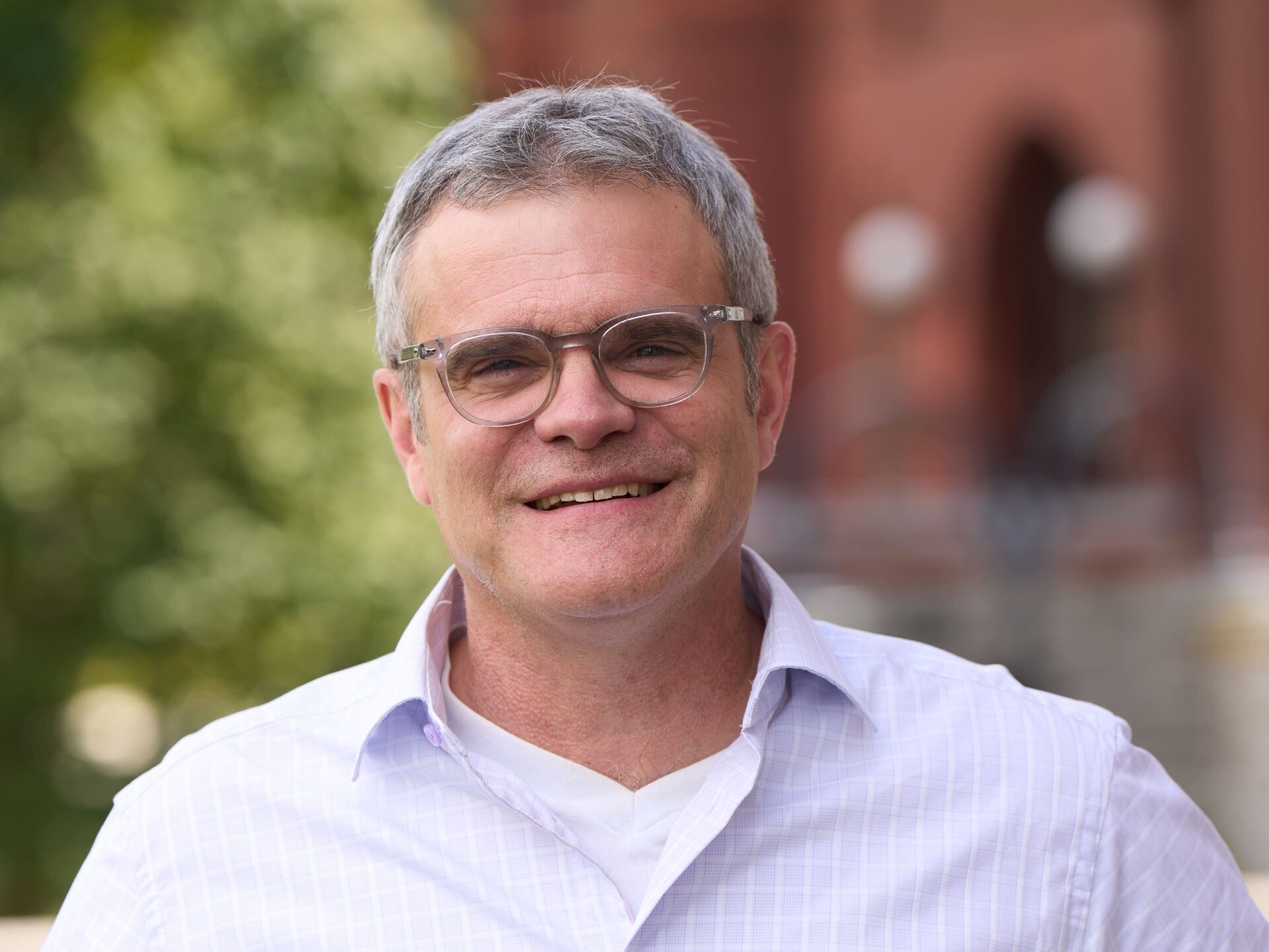 Professor Bob Wilson stands infront of the camera for a headshot