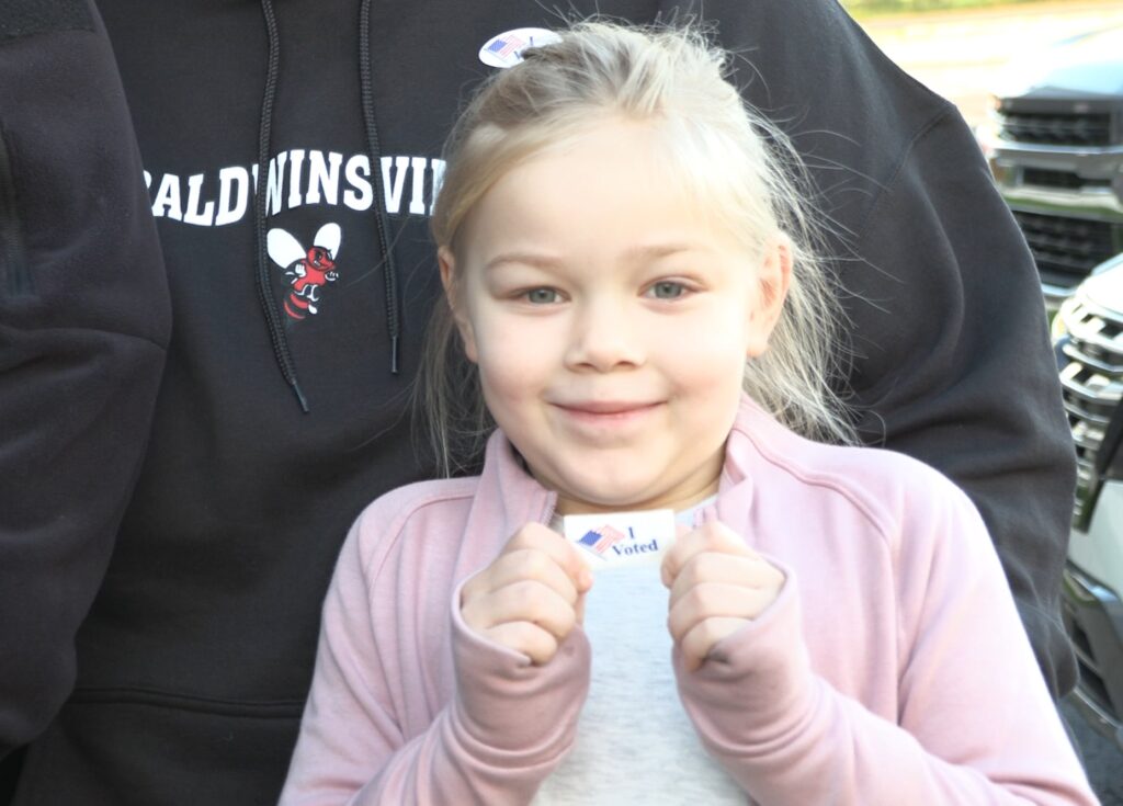 Victoria Wells smiling with an "I Voted" sticker.
