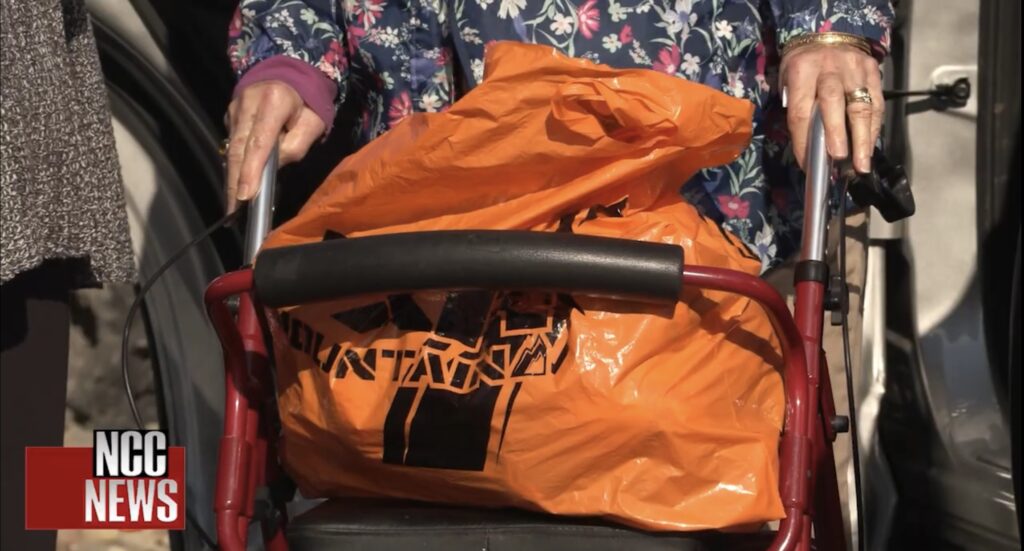 Residents speaking with Diana Sleiertin in the parking lot of in Bailiwick Market and Cafe in the town of Elbridge in Onondaga County . ©2025 Keleigh Arrington