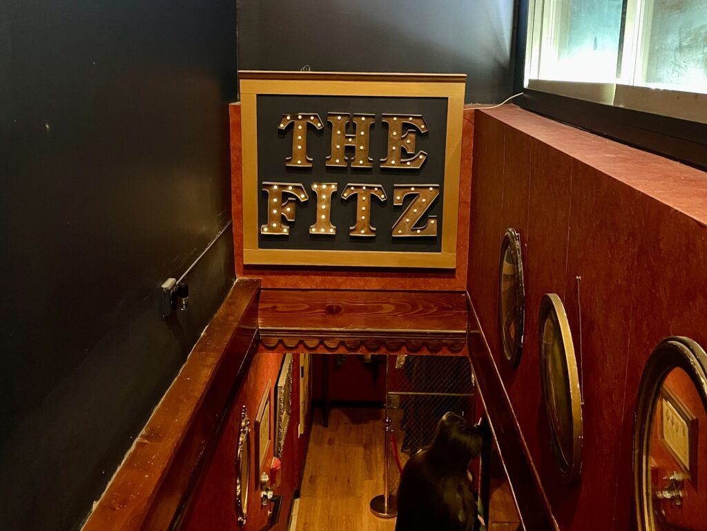 The Fitz's sign down the stairs in Oh My Darling.