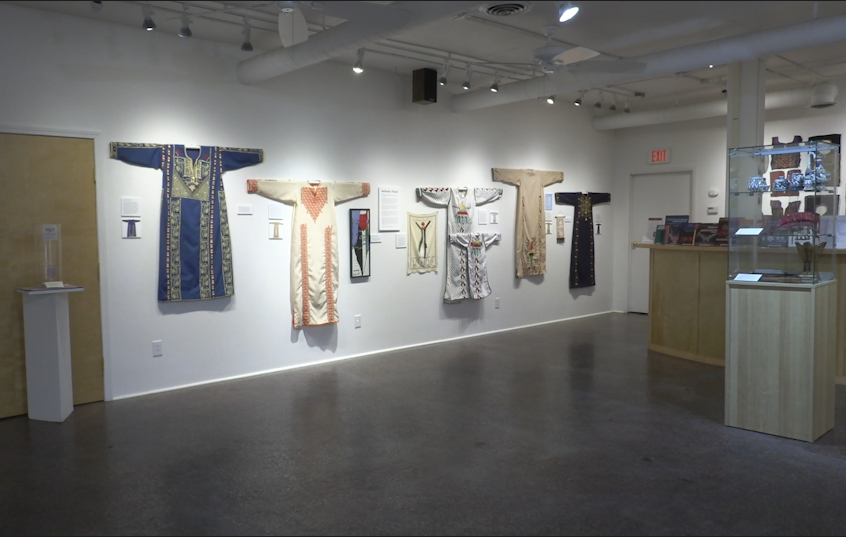 Palestinian dresses hanging on a wall