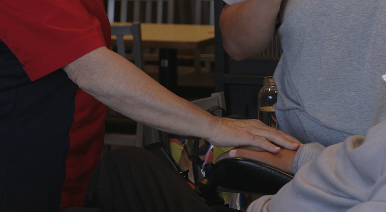 Woman comforts owner of the Chick-fil-A during conversation.