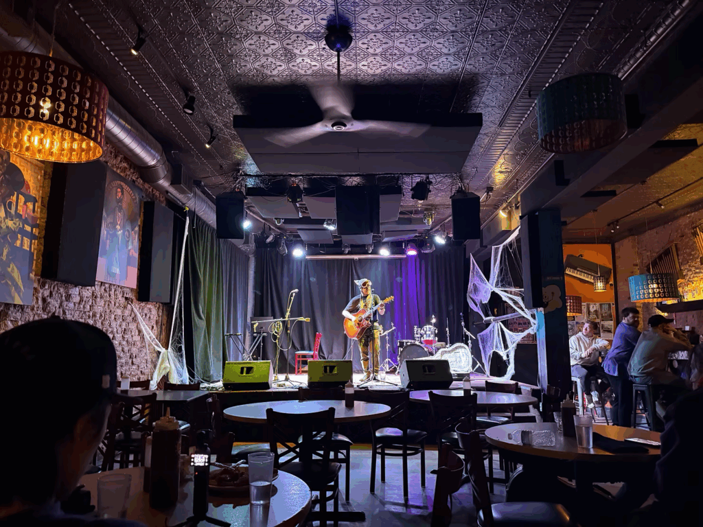 The first act of open-mic night takes the stage to sing an original