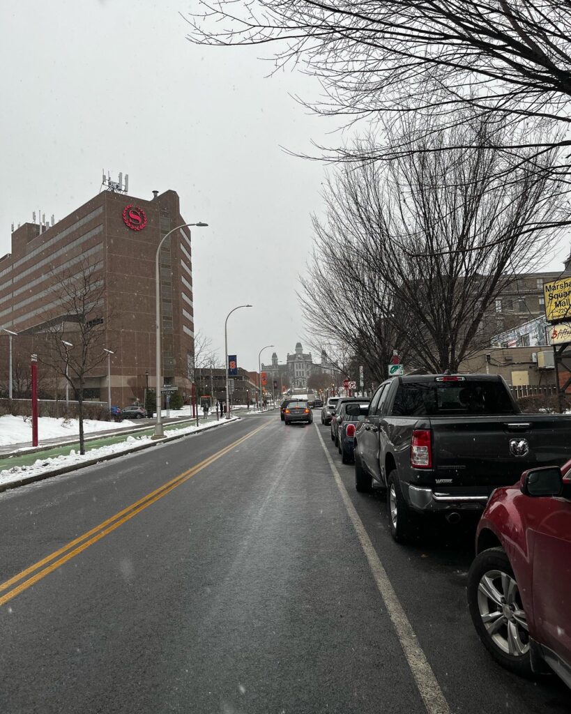 Syracuse University's Hall of Languages from University Avenue through flurries of snow