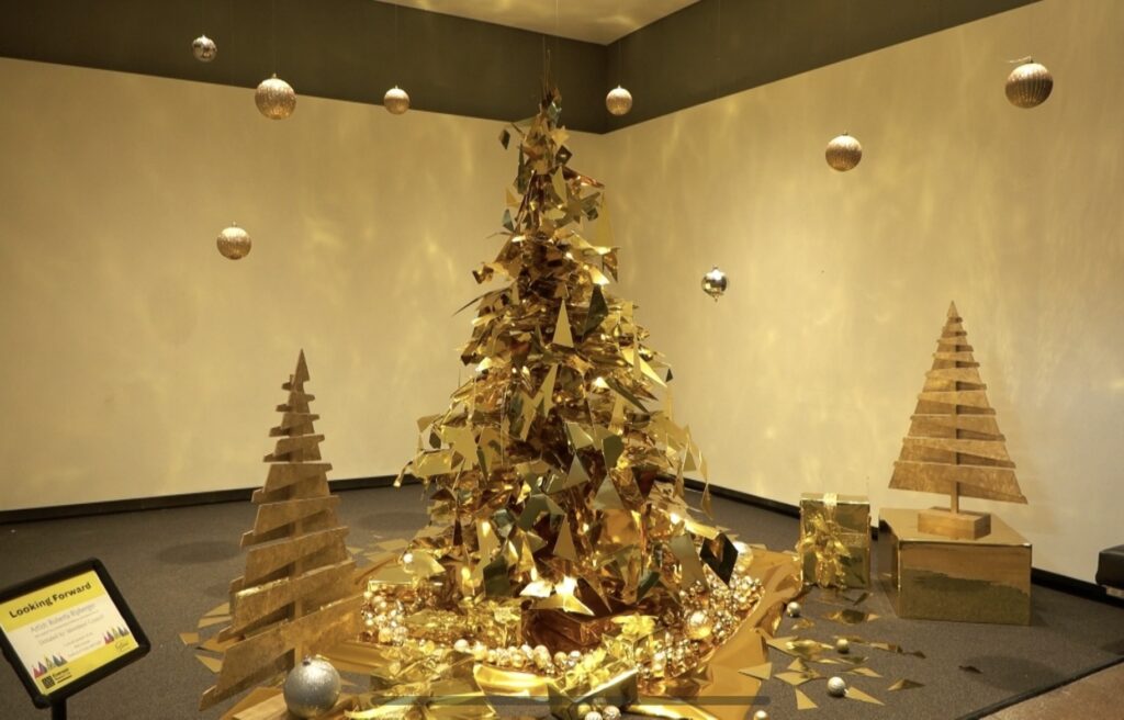Golden Christmas tree made out of triangle-shaped shiny glass