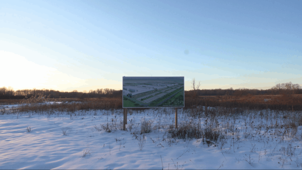 Micron sign in Clay on the project site displaying an image of their future complex.