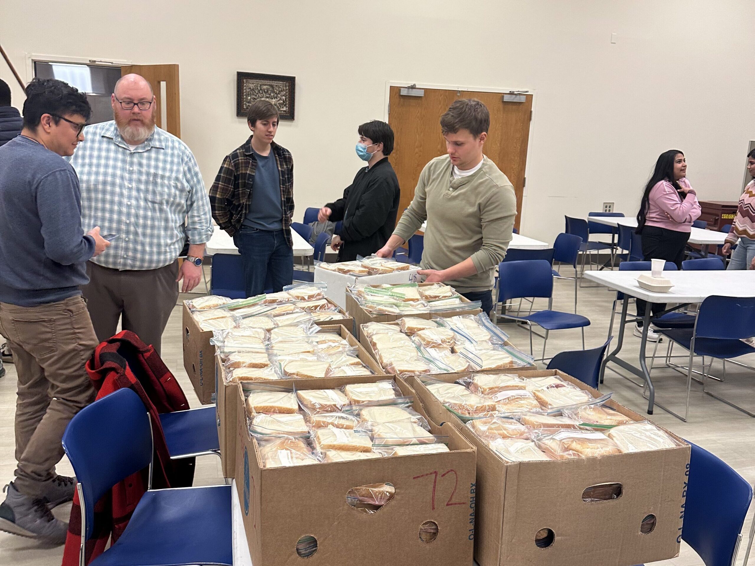 Over 700 Bologna and cheese sandwiches, bagged and boxed, ready to transport for Friday's delivery.