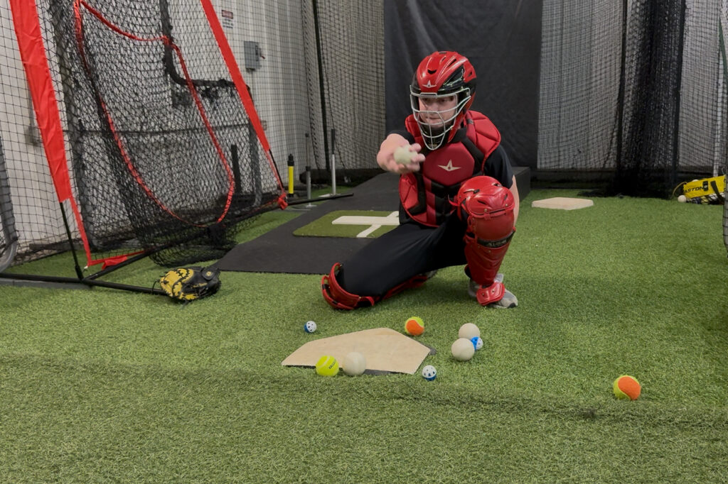 Josh Newton performing a catcher receiving drill. © Joey Cicini. 2026