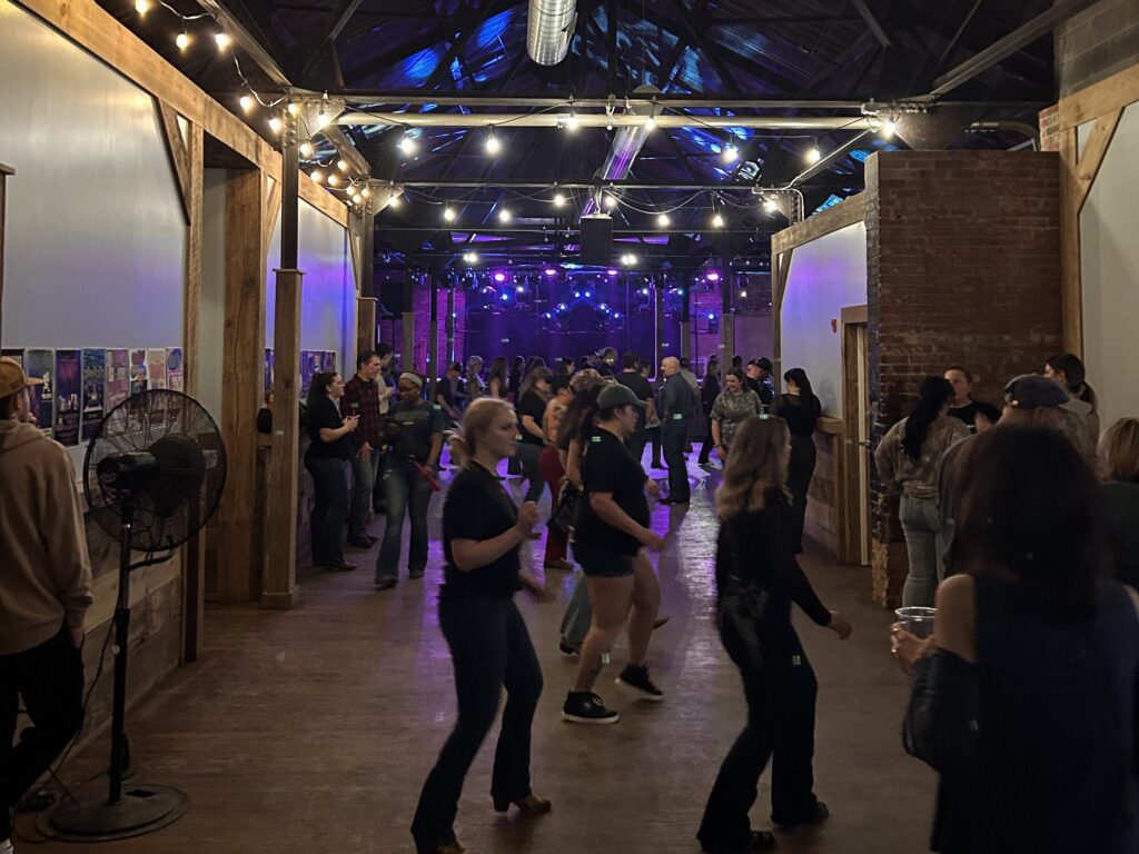People line dance at Middle Ages Brewery during Boots at the Brewery, a community event hosted in collaboration with Erie & Ivy Events. © Ku'ulei Kahale