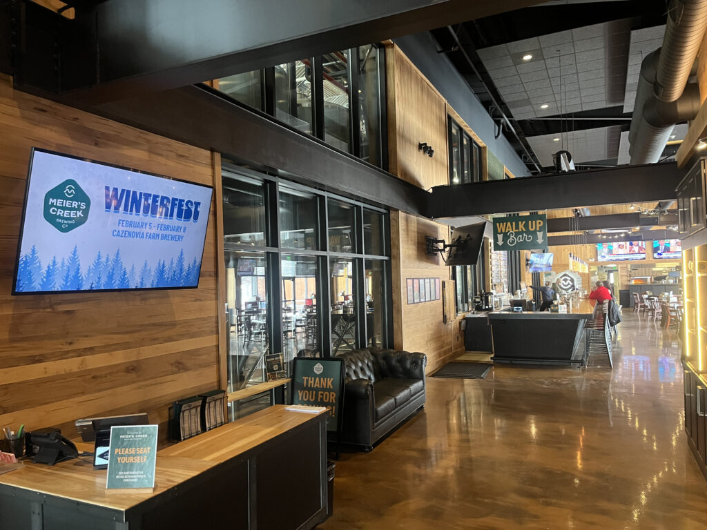 The wooden interior and green/brown colors represent the inside of the Meier's Creek brewery.