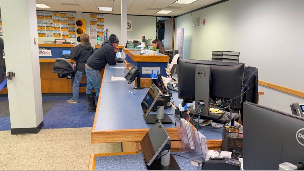 DMV clerks assist customers at a service counter inside a New York State Department of Motor Vehicles office in Madison County, New York, ahead of the upcoming technology upgrade. © Keleigh Arrington