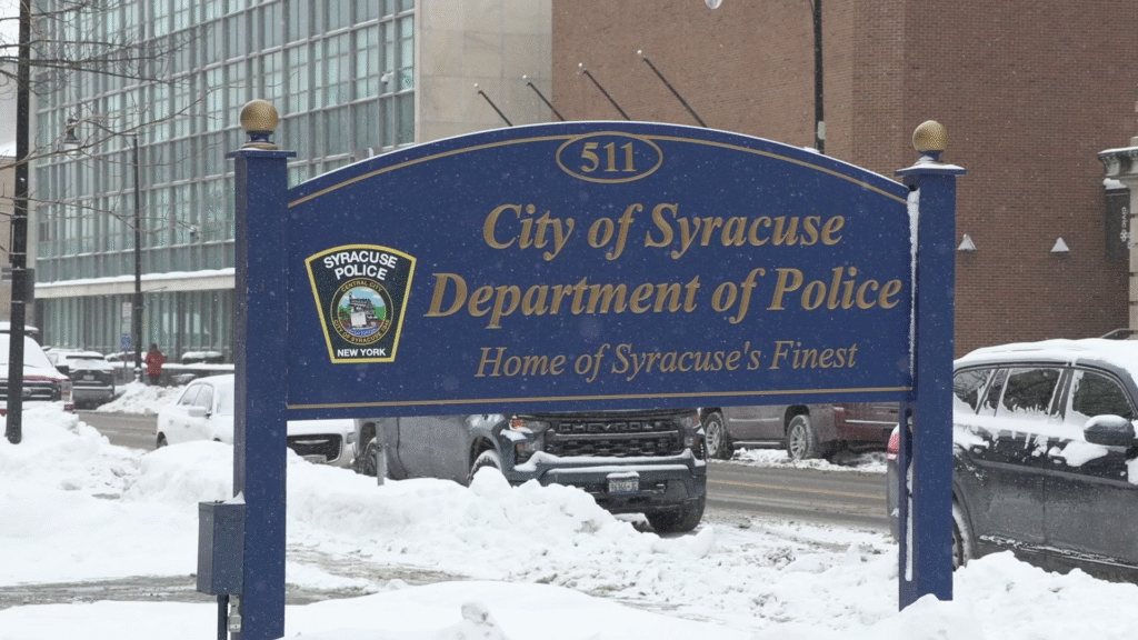 The Syracuse Police Department sign, with snow in the background. © Rece Allen