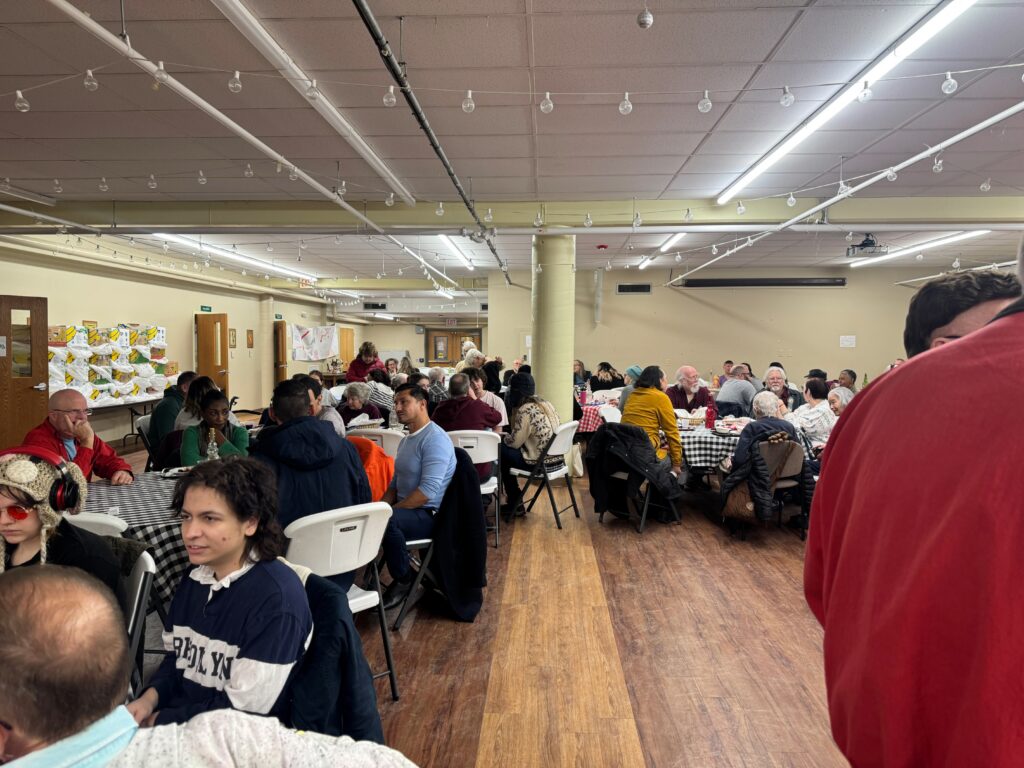 People eating and talking at the Friends of Dorothy House Dinner.